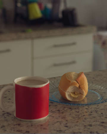 Brazilian breakfast. Cup of coffee and toasted bread with butter in the kitchen.の写真素材