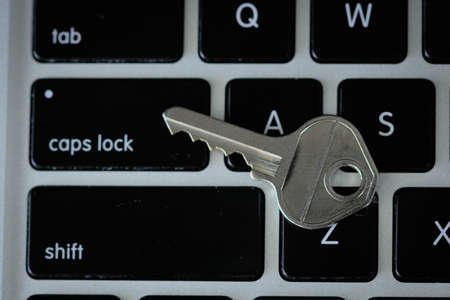 Key at keyboard. Security concept image