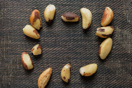 Brazilian nuts in a bowl on a wooden table.