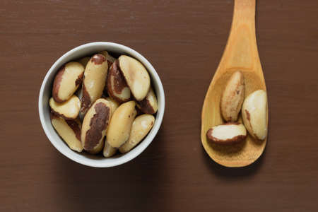 Brazilian nuts in a bowl on a wooden table.