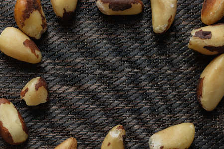 Brazilian nuts in a bowl on a wooden table.の写真素材