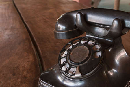 Old Beige phone retro on a wood tableの写真素材