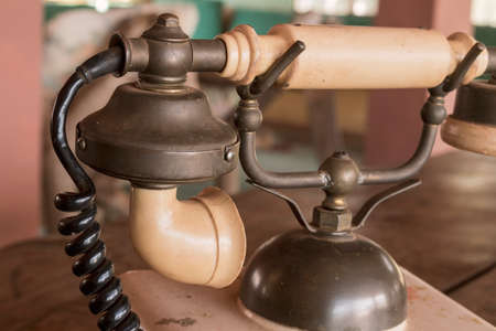Old Beige phone retro on a wood table
