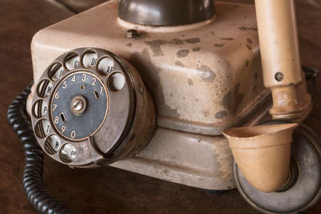 Old Beige phone retro on a wood tableの写真素材