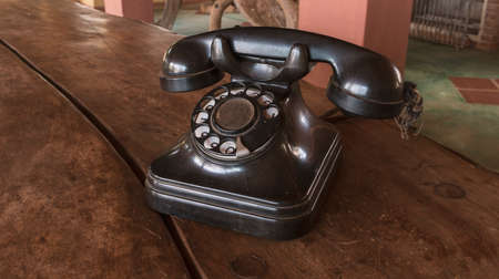 Old Beige phone retro on a wood tableの写真素材