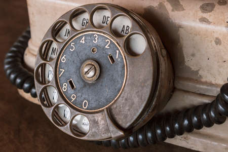 Old Beige phone retro on a wood tableの写真素材