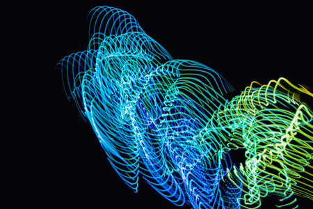 Futuristic overlay light pattern.Abstract neon lights trails in the black background.