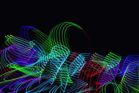 Futuristic overlay light pattern.Abstract neon lights trails in the black background.