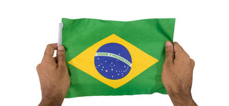 Holding a brazilian flag isolated on white background.