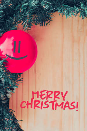 Merry Christmas text.. Merry Christmas background with xmas tree and wood table.