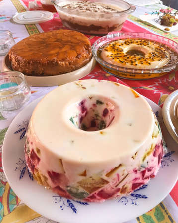 Colored gelatin, passion fruit mousse, coconut custard and apple pie. Table of famous Brazilian...