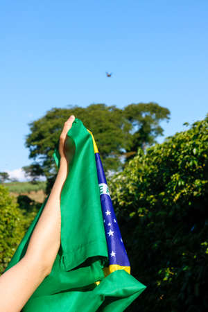 Brazilian flag concept image. Holding the Brazilian flag in the wind.の写真素材
