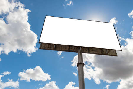 Billboard - Empty billboard in front of beautiful cloudy sky in a rural location. Space for text or designの写真素材