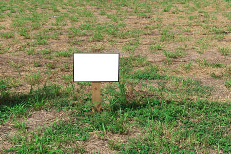 Billboard - Empty billboard in front of beautiful cloudy sky in a rural location. Space for text or designの写真素材