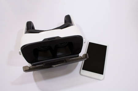 VR Glasses or Virtual Reality Headset helmet with cell phone isolated on white background for...