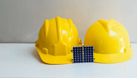 Solar Cell Energy concept image. Solar panel, safety helmet and work tools isolated on white, top viewの写真素材