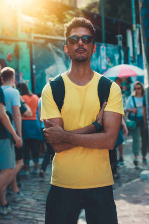 Handsome Black Man in Yellow Shirt and Glasses on Street Background Defocused People.の写真素材