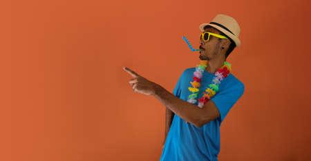 man in costume for brazil carnival isolated on orange background