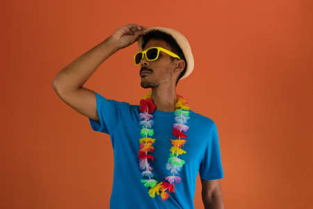 Black man in costume for brazil carnival isolated on orange backgroundの写真素材