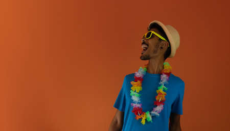 Black man in costume for brazil carnival isolated on orange background.