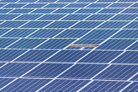 Focus on front a arranged solar photovoltaic panels.