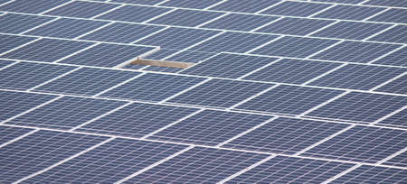 Focus on front a arranged solar photovoltaic panels.