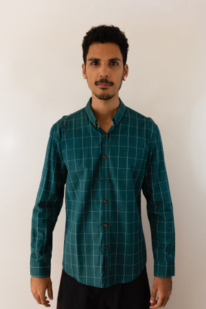 Black man in a social shirt in the studio isolated on yellow background.の写真素材
