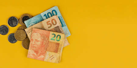 Brazilian money varied valures isolated on yellow background. Brazil economy concept.の写真素材
