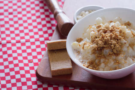 Brazilian dessert sweet canjica of white corn with pacoca sweet. Brazilian winter sweet of Junina festival party.の写真素材