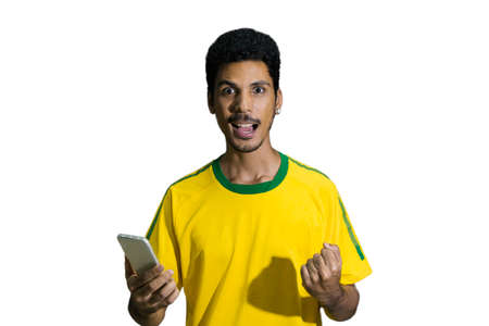 Male athlete or fan in yellow uniform looking cell phone isolatedの写真素材