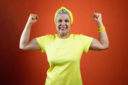 Brazil Independence Day - Mature Woman with Gray Hair, yellow shirt isolatedの写真素材
