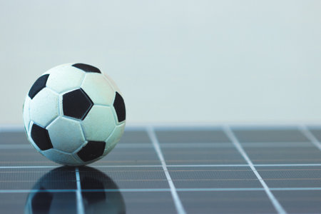 Soccer ball on photovoltaic solar panel isolated.