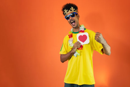 Brazilian Player- Black Man Celebrating With Yellow T Shirt Isolatedの写真素材