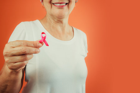 Breast Cancer Protection Symbol - Mature Woman With Pink Ribbon on and White t shirt isolatedの写真素材