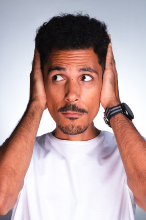 Authentic Portrait - Handsome Black Man Making Expressions with White Shirtの写真素材