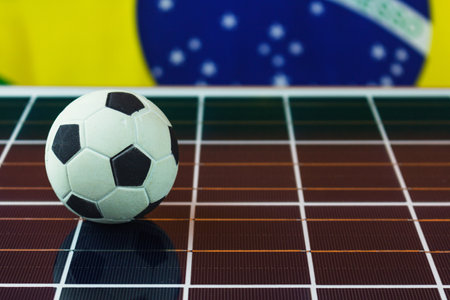 Soccer Ball and Brazil Flag over Photovoltaic Solar Panel. Cup and Technology Conceptの写真素材