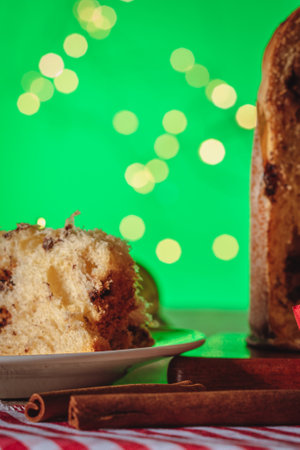 Fruit and Chocolate Chips Cake Served on a Wood Table decorated for Christmas. Homemade Christmas Even Bread on Green Background, Copy Space.の写真素材