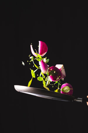 Making Brazilian-style Ceviche on Black Background. Frying Pan Throwing Ingredients Like Red Onion,...
