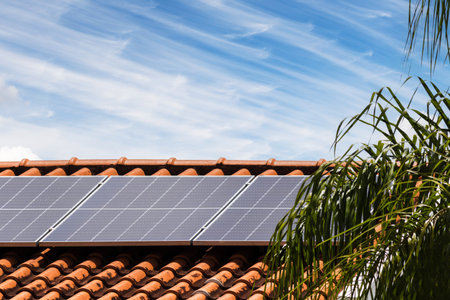 Solar Panels on the Roof in a Sunny and Cloudy Day. Photovoltaic Installation Plant in a House With...