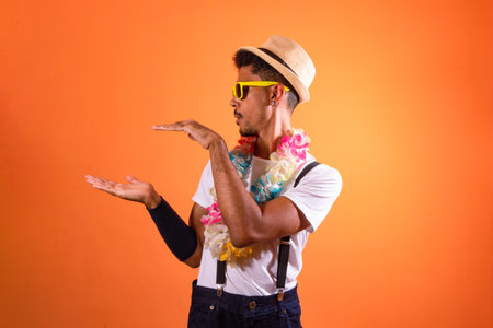 Carnival Outfit Party. Portrait of Black Man With Carnival Props Isolated on Orange Background,...