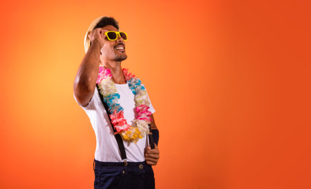 Carnival Outfit Party. Portrait of Black Man With Carnival Props Isolated on Orange Background,...