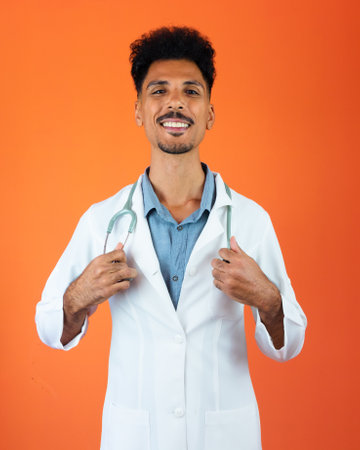 Black Brazilian Doctor Medical Resident With Stethoscope on Orange Background.の写真素材