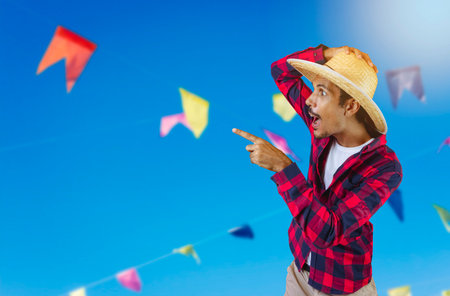 Black Man With Hat on Junina Party Outfit Background.の写真素材
