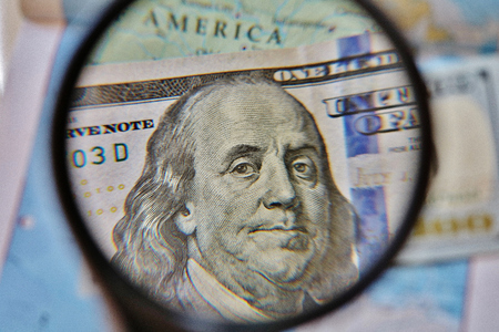 Hundred dollar bill through a magnifying glass