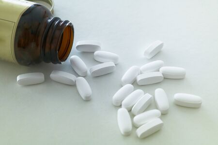 Pills spilled from a bottleの写真素材