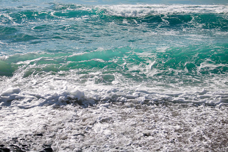Turquoise clear blue rolling wave with white seafoamの写真素材