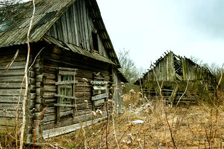 Old abandoned wooden house with boarded up windowsの写真素材
