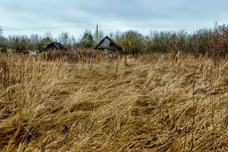 Old abandoned wooden house with boarded up windowsの写真素材