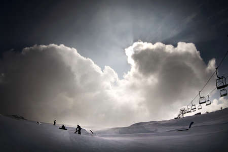Sunny day on dolomites, clouds on snowparkの写真素材