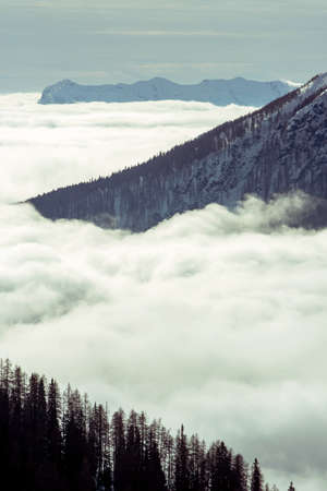 Sunny day on dolomites, sea of clouds and cross processingの写真素材